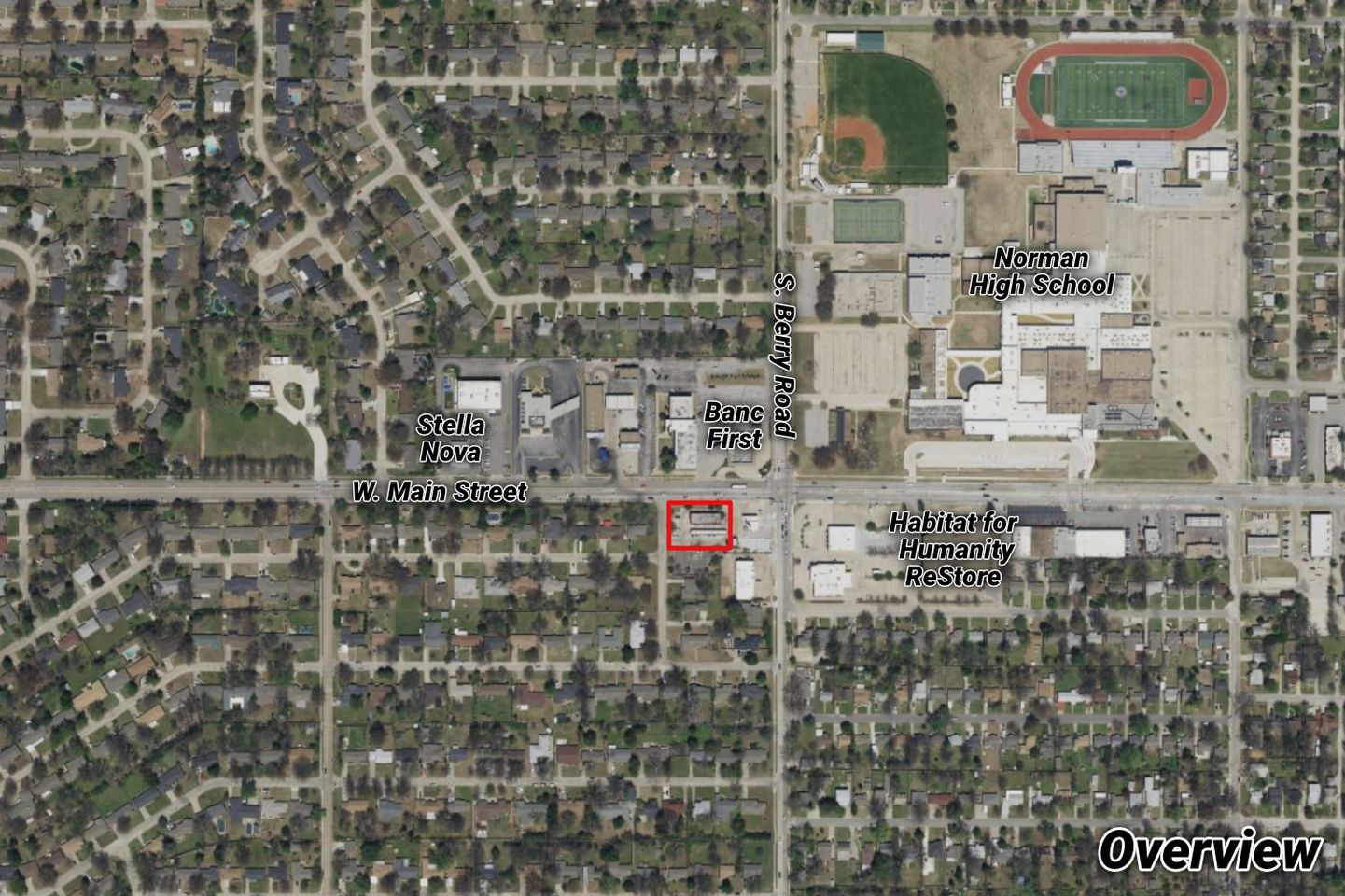 Aerial overview of the W. Main Street site outlined in red near Norman High School, Stella Nova, BancFirst, and the Habitat for Humanity ReStore.